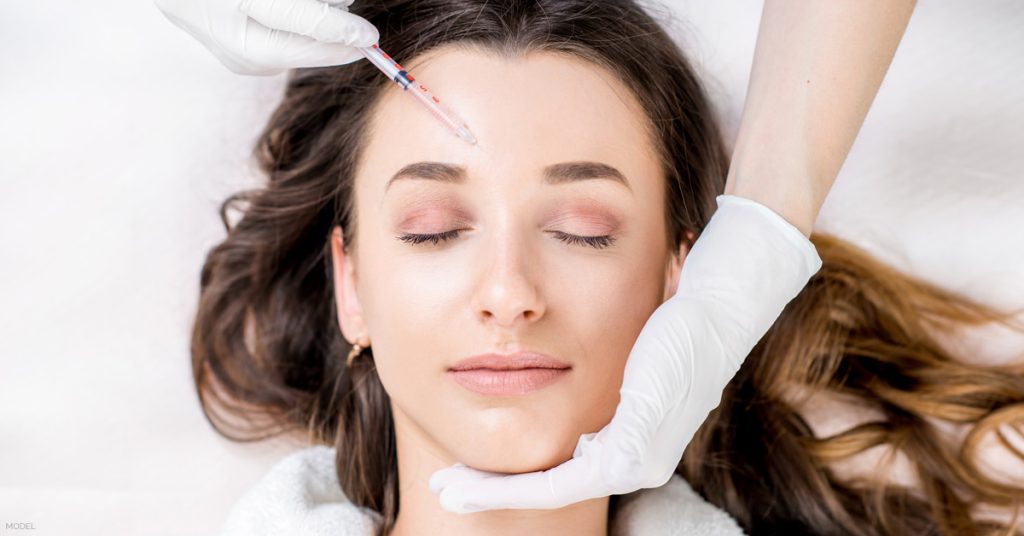 Woman receiving injectable filler treatment in Des Moines, Iowa.